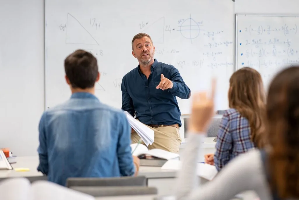 CRAMEd Tech classroom with an instructor teaching students at a whiteboard